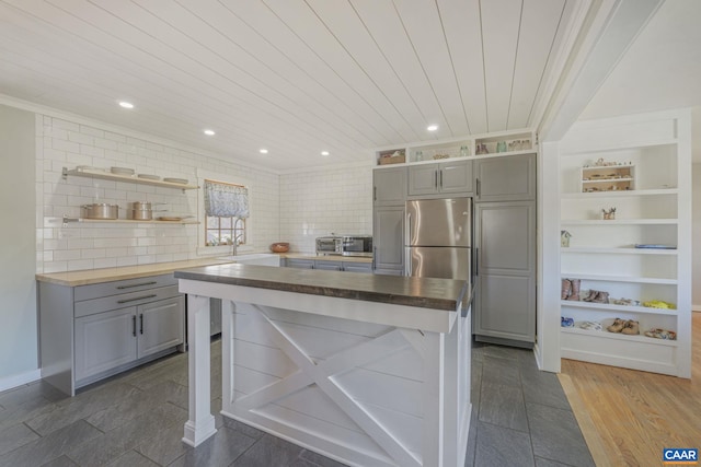 kitchen with open shelves, crown molding, gray cabinets, and wooden counters