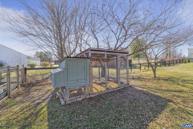 view of poultry coop with a lawn and fence