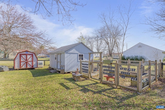 view of yard with a vegetable garden, a storage unit, and an outdoor structure