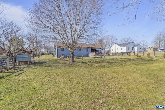 view of yard featuring an outdoor structure and fence