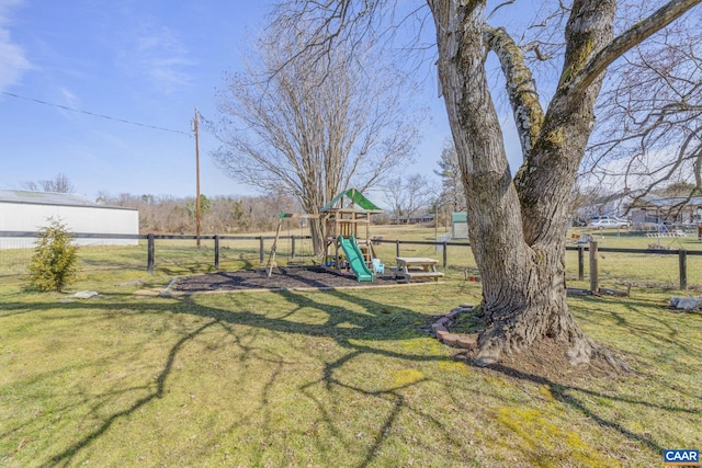 view of yard featuring a playground and fence