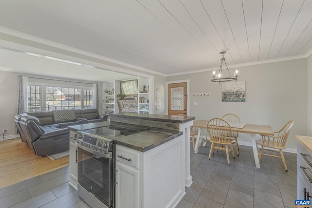 kitchen featuring ornamental molding, dark countertops, white cabinetry, stainless steel electric range, and hanging light fixtures