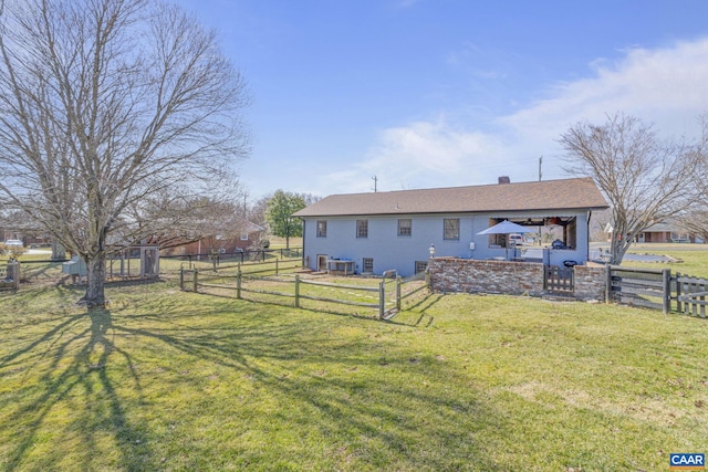 view of yard featuring a gate, central AC, and fence