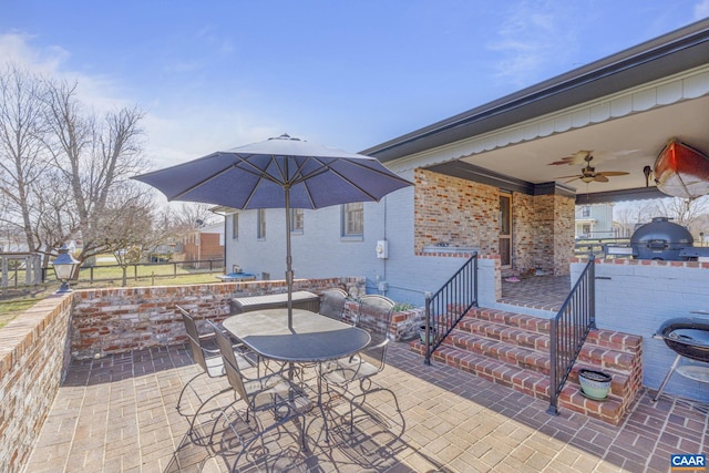 view of patio / terrace featuring outdoor dining space, a ceiling fan, fence, and a grill