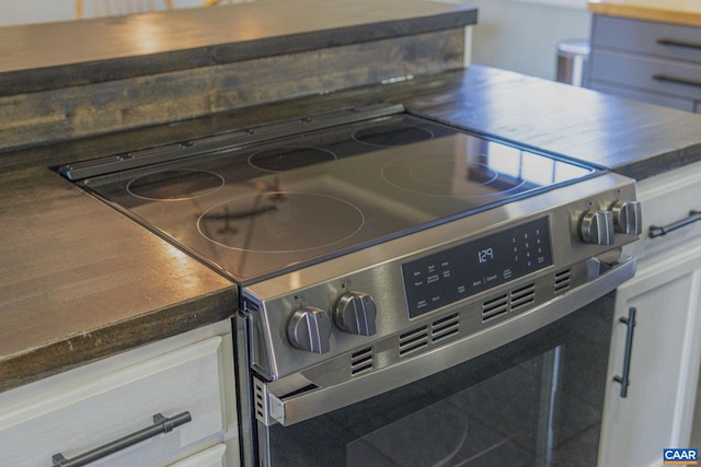 interior details with dark countertops and range with electric cooktop