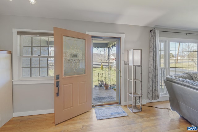 entryway featuring recessed lighting, plenty of natural light, light wood-style flooring, and baseboards