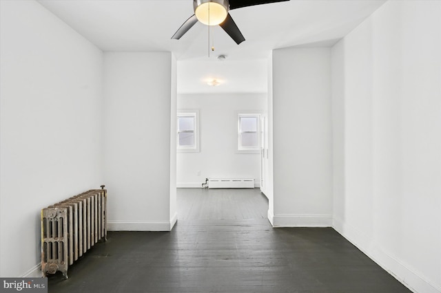 hallway featuring radiator heating unit, wood finished floors, baseboards, and baseboard heating