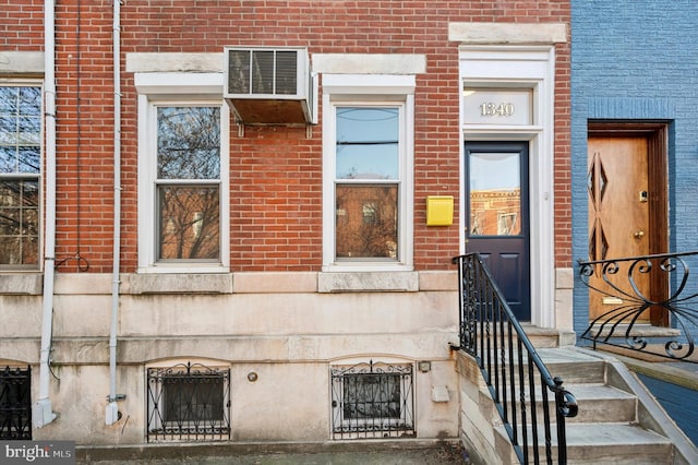 entrance to property featuring brick siding