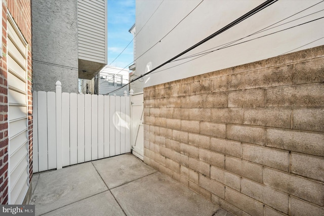 view of patio with radiator heating unit and fence