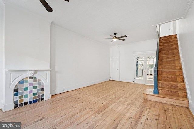 unfurnished living room with a ceiling fan, hardwood / wood-style floors, stairs, and ornamental molding