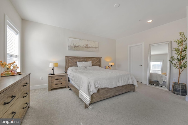 bedroom with light carpet, recessed lighting, and baseboards