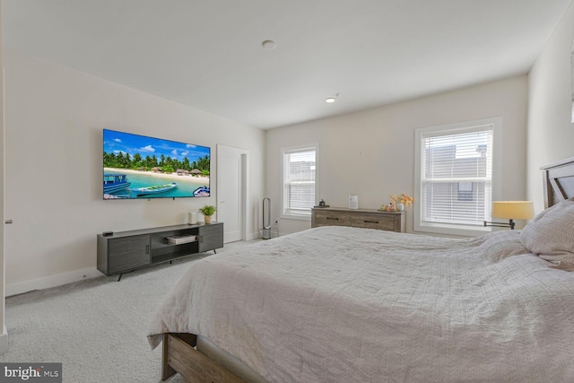 bedroom with baseboards and carpet