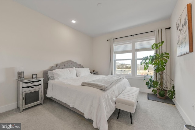 bedroom featuring baseboards and light carpet