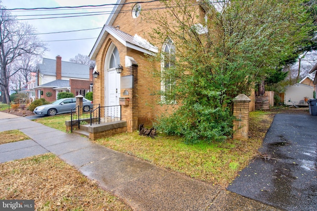 view of property exterior with brick siding