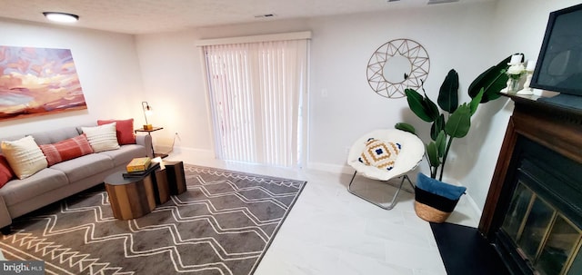 living room with visible vents, baseboards, and a fireplace