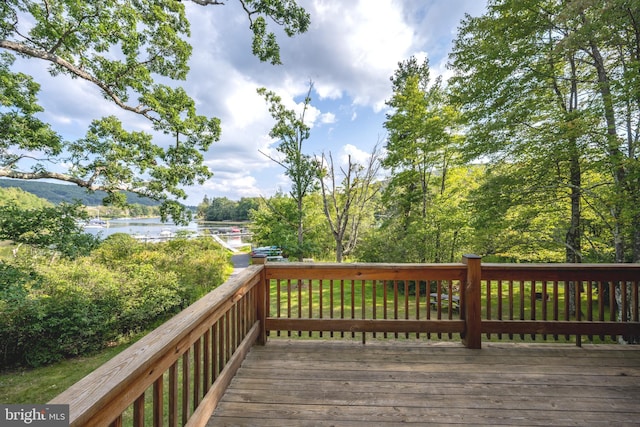 wooden terrace featuring a water view