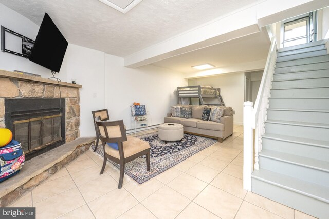 living room with tile patterned floors, a stone fireplace, a textured ceiling, and stairs