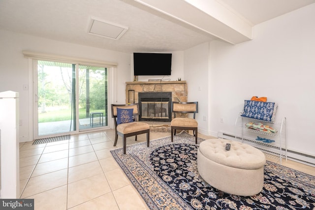 living area with baseboards, attic access, beam ceiling, a fireplace, and tile patterned flooring