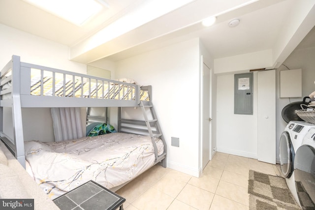 bedroom featuring electric panel, baseboards, separate washer and dryer, and tile patterned floors