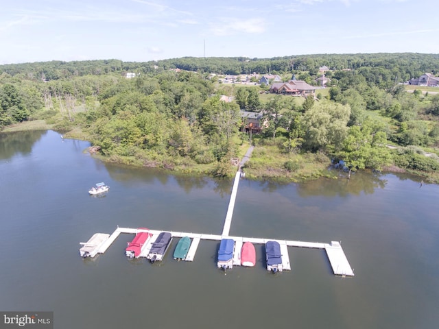 aerial view with a wooded view and a water view