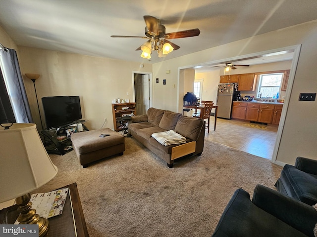 living room featuring light colored carpet and ceiling fan