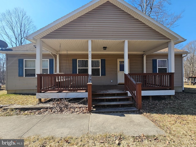 view of front facade with a porch and a shingled roof