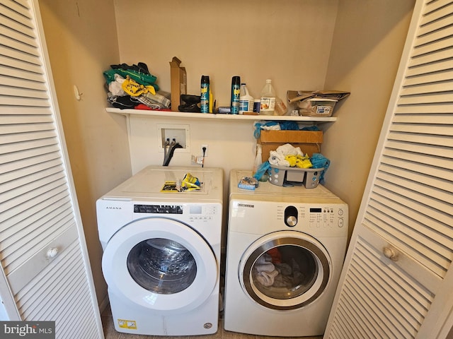 washroom featuring separate washer and dryer and laundry area