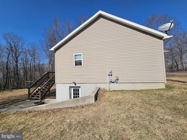 view of side of home featuring stairs