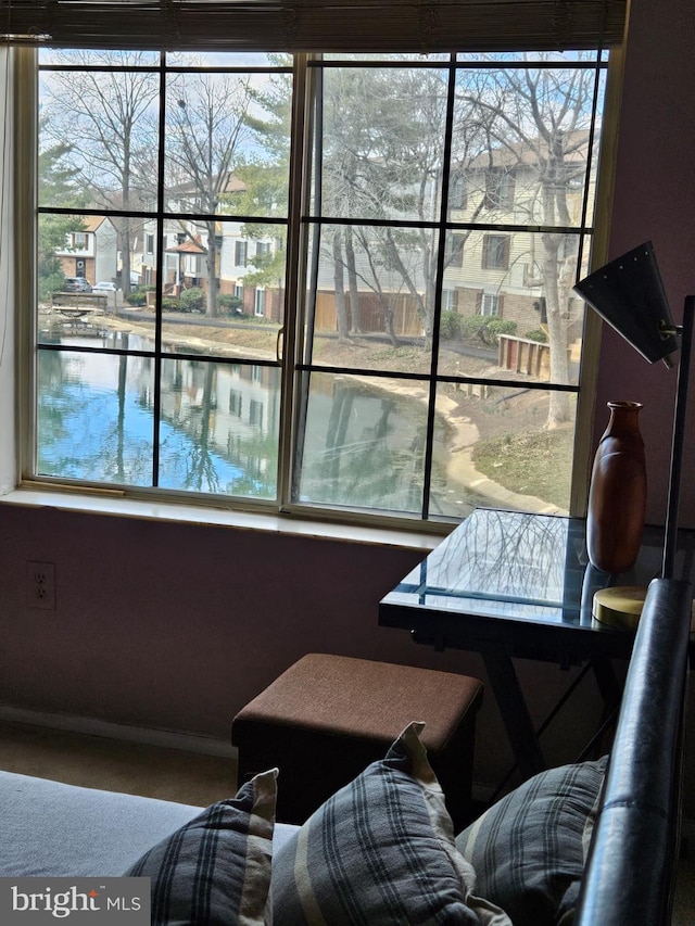 interior space featuring a wealth of natural light and a water view