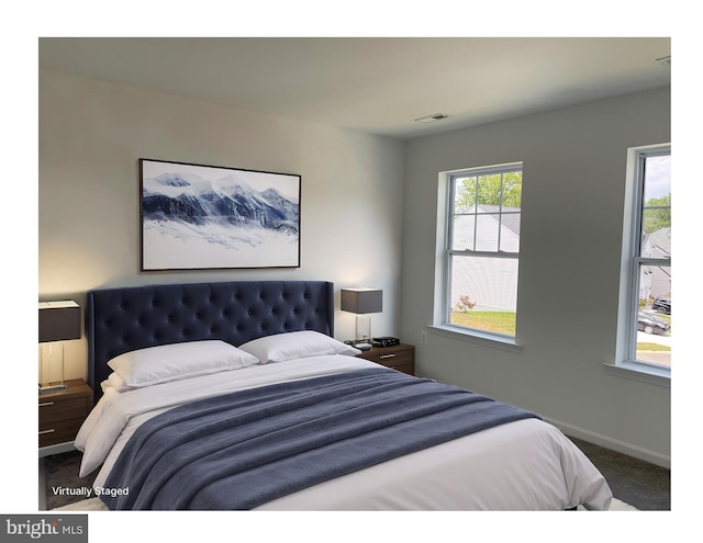 bedroom featuring carpet, visible vents, and baseboards