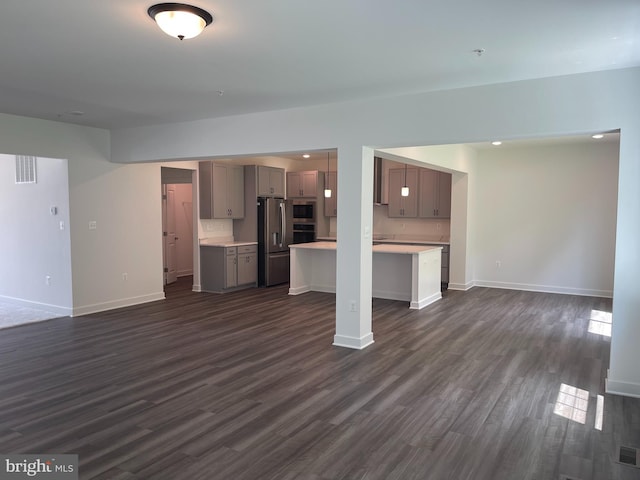 unfurnished living room featuring recessed lighting, visible vents, baseboards, and dark wood-style flooring