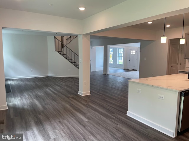 unfurnished living room featuring stairway, recessed lighting, baseboards, and dark wood-style flooring