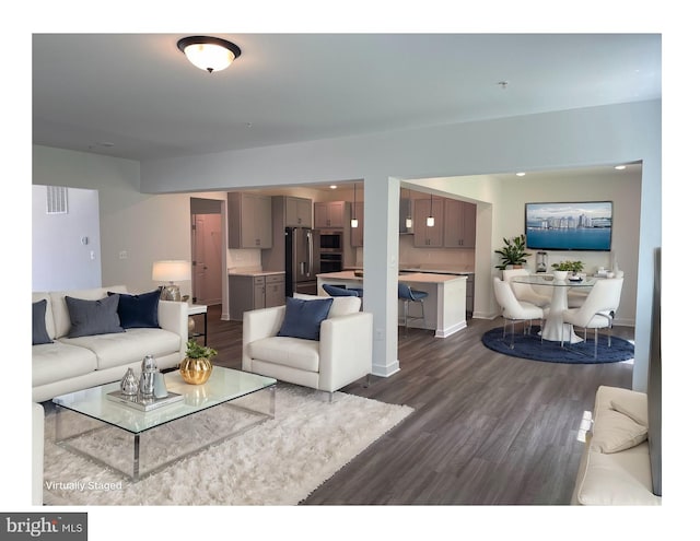 living area with recessed lighting and dark wood-style flooring