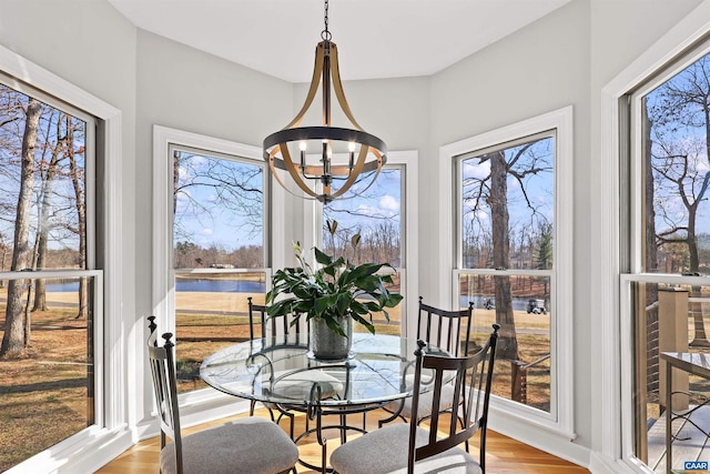 sunroom with a notable chandelier and a healthy amount of sunlight