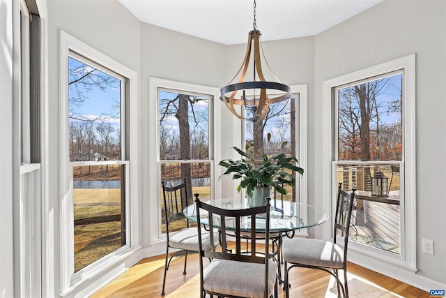 dining space featuring a notable chandelier and light wood-style floors