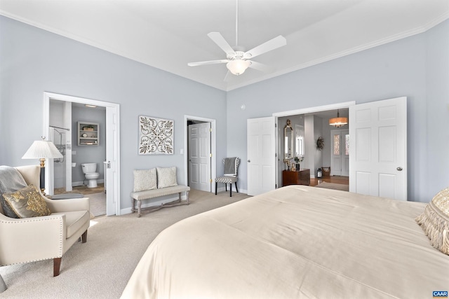 carpeted bedroom with ceiling fan, ensuite bath, crown molding, and baseboards