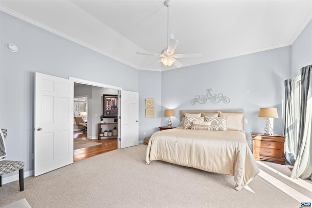 bedroom featuring carpet flooring, a ceiling fan, baseboards, and ornamental molding