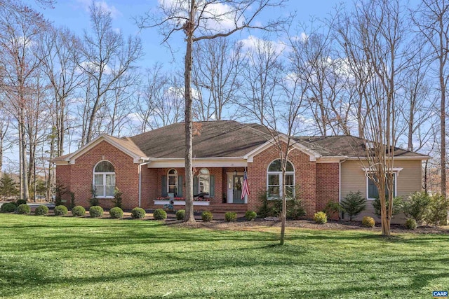 ranch-style house with brick siding, a porch, and a front yard