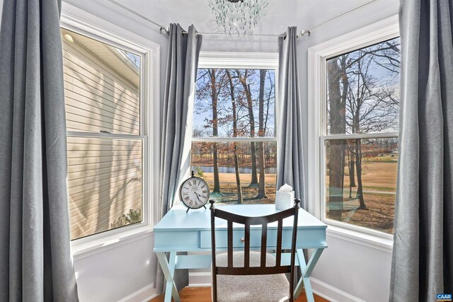 dining room featuring baseboards and a notable chandelier