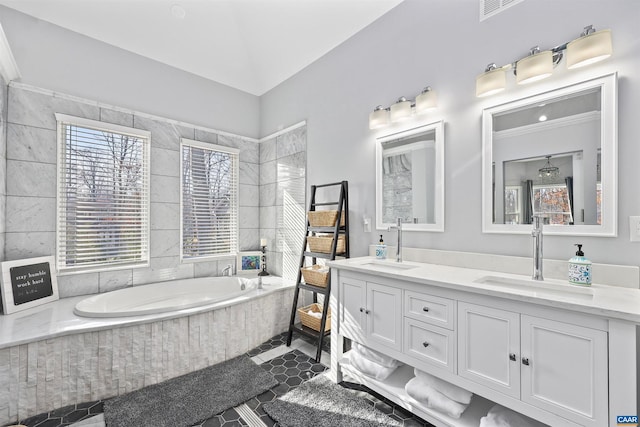 bathroom featuring a sink, a garden tub, double vanity, and tile patterned flooring