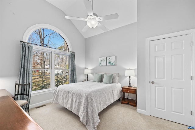 bedroom with visible vents, baseboards, high vaulted ceiling, ceiling fan, and light carpet