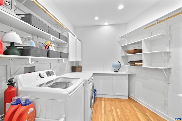 washroom featuring separate washer and dryer, recessed lighting, cabinet space, and light wood finished floors