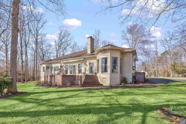 back of house with a wooden deck, a yard, a chimney, stairs, and crawl space