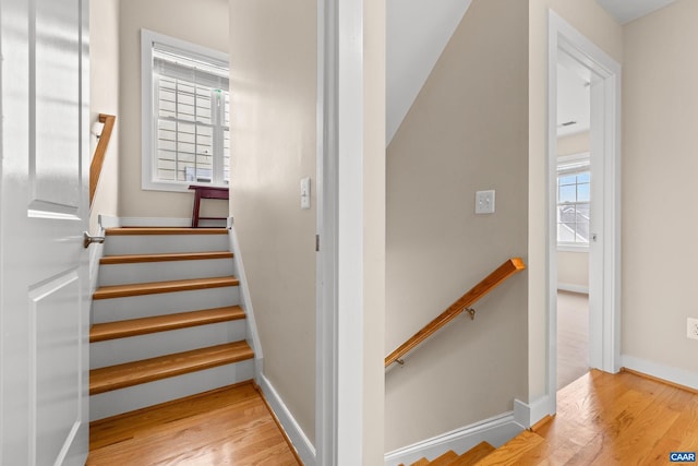 stairway featuring baseboards and wood finished floors