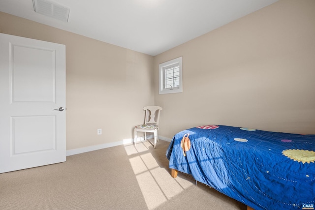 carpeted bedroom with visible vents and baseboards