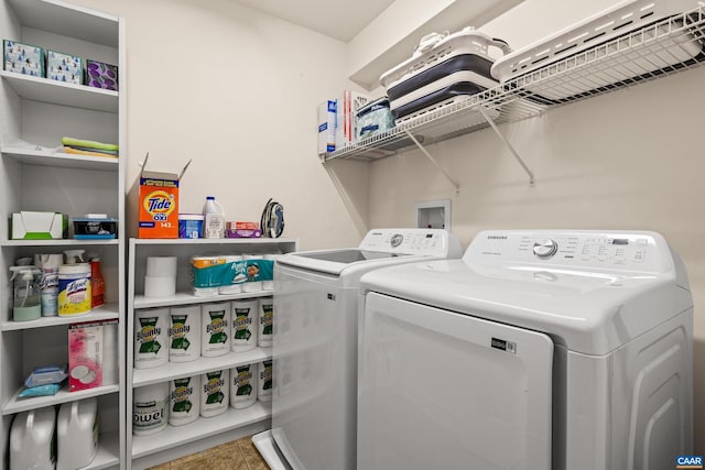 laundry area with washer and dryer, laundry area, and tile patterned floors