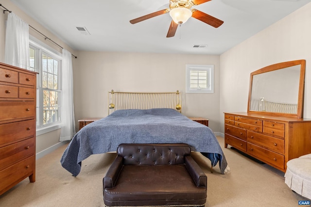 carpeted bedroom featuring visible vents, baseboards, and a ceiling fan