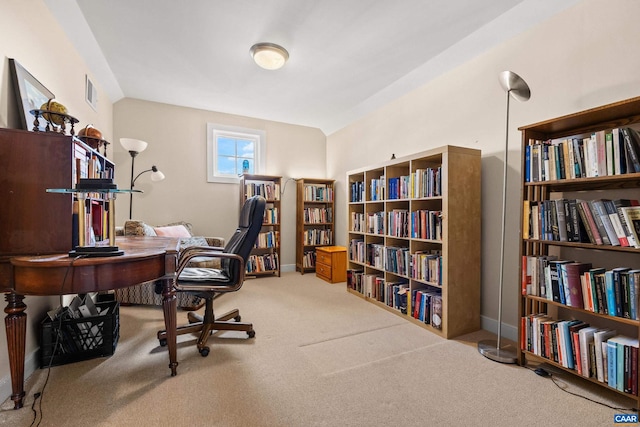 office space featuring visible vents, baseboards, lofted ceiling, and carpet floors