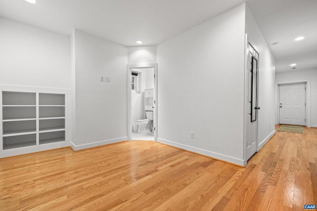 hall featuring recessed lighting, light wood-type flooring, and baseboards