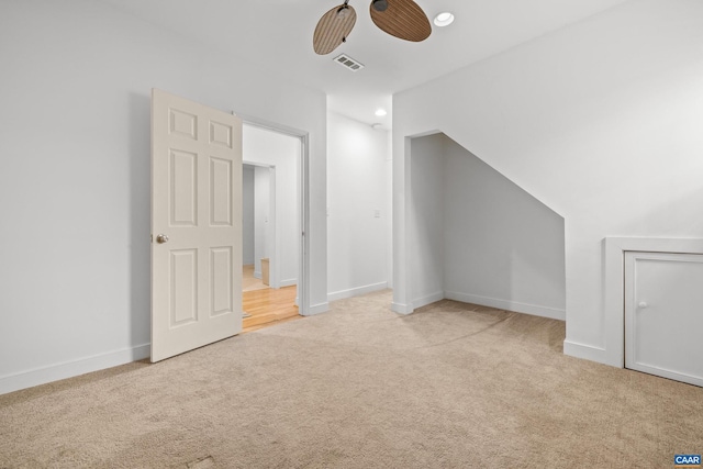 additional living space with visible vents, baseboards, ceiling fan, and carpet flooring